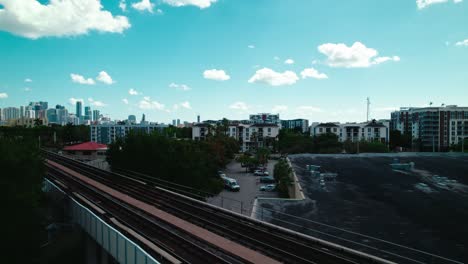 revealing miami skyline behind elevated rail tracks