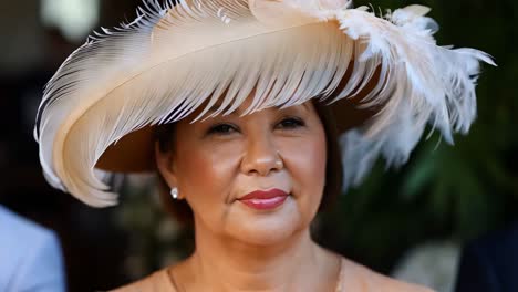 woman wearing a large feather hat