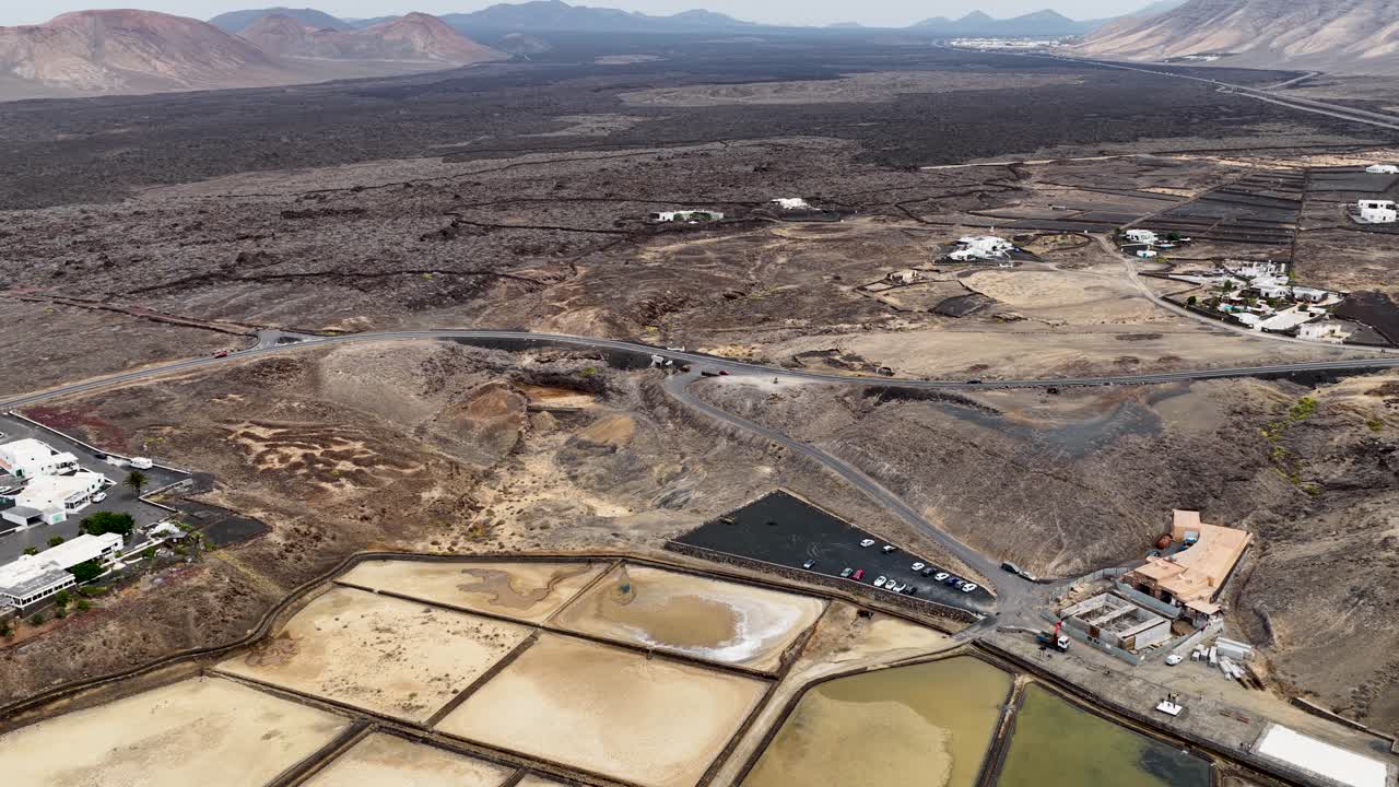 Salinas de Janubio salt flats aerial view descending across the vast volcanic mineral mining site