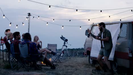 laughing diverse friends playing charades in camp