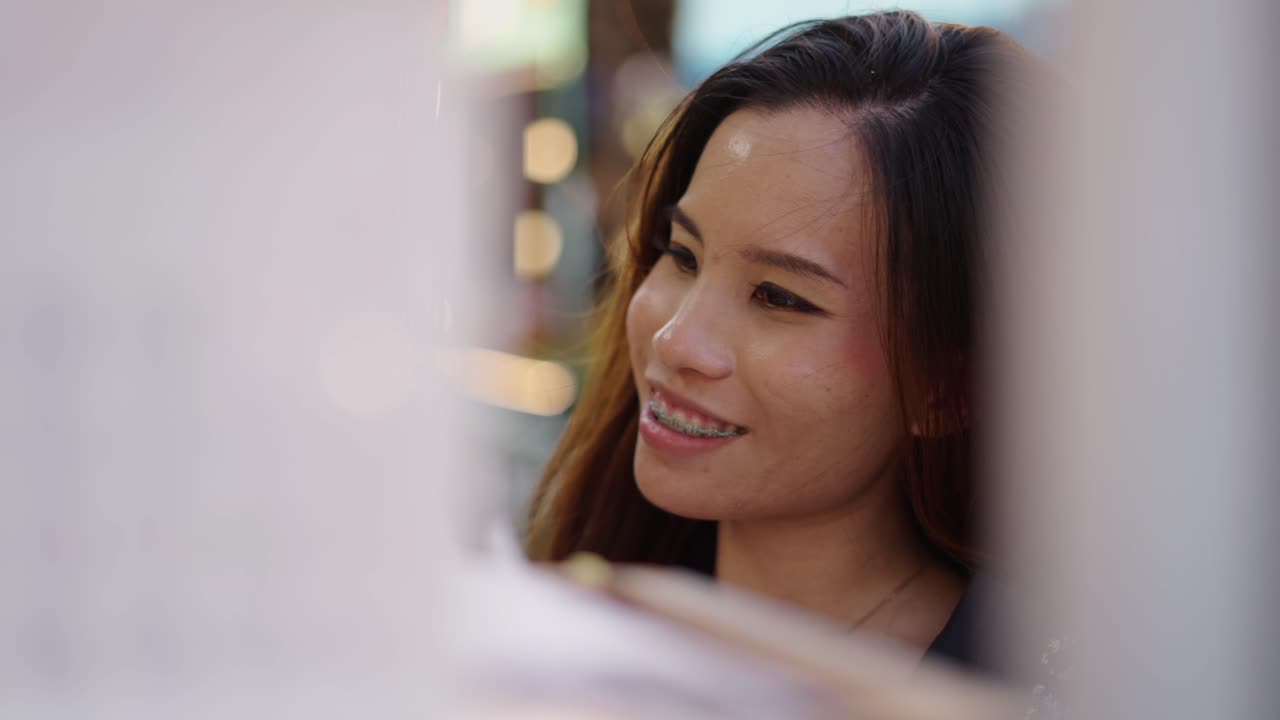 Portrait of a Smiling Young Asian Woman with Braces