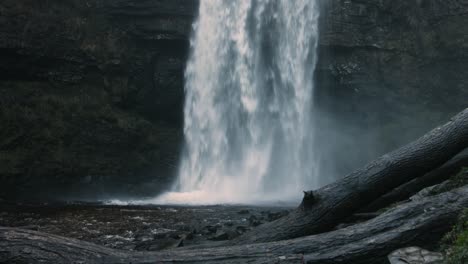 cascading white waterfall crashing down after heavy rain in wales uk