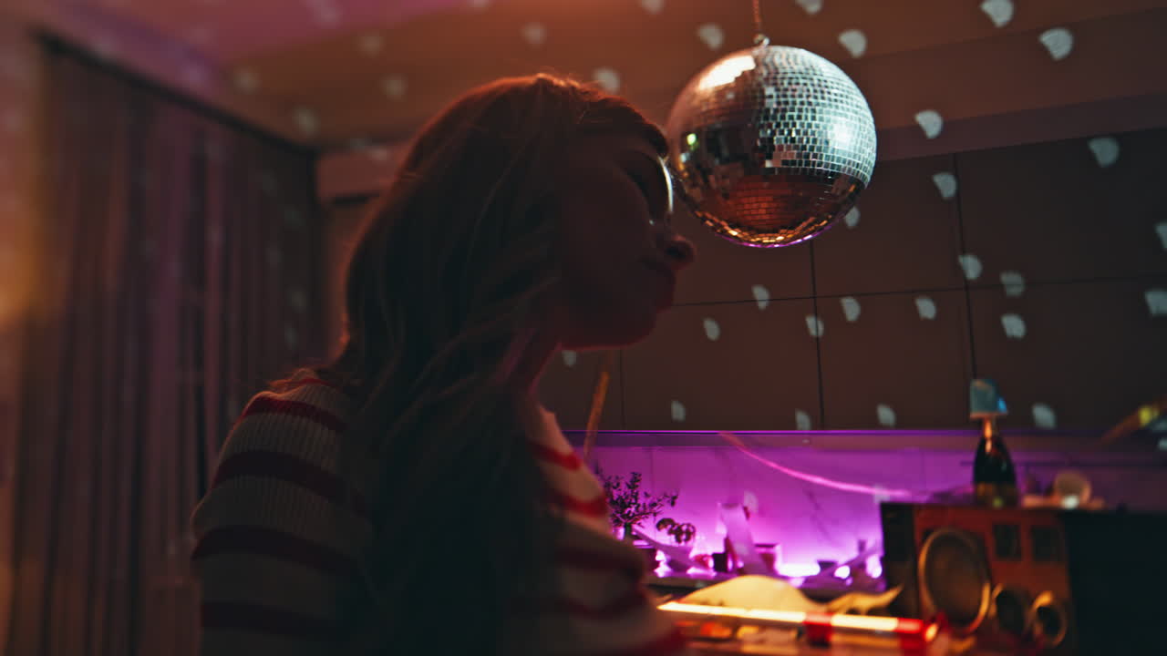 Silhouette relaxed girl dancing under disco ball alone close up. Woman lonely