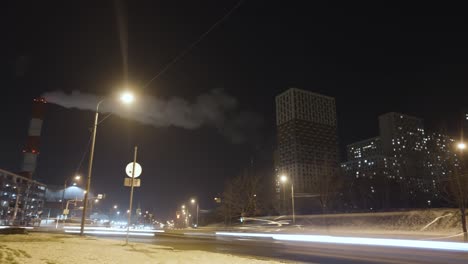 night cityscape with apartment buildings and traffic