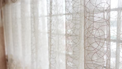 white sheer curtains with a subtle pattern