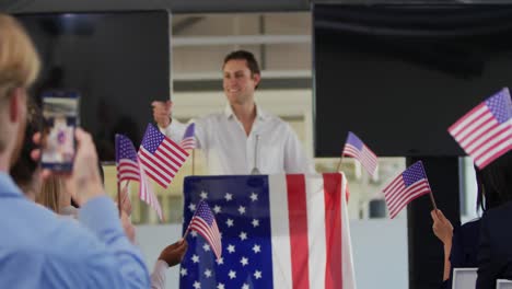 Victorious-male-speaker-and-audience-at-political-convention