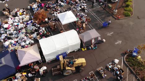 aerial of workers loading donations at camp fire distribution center in california