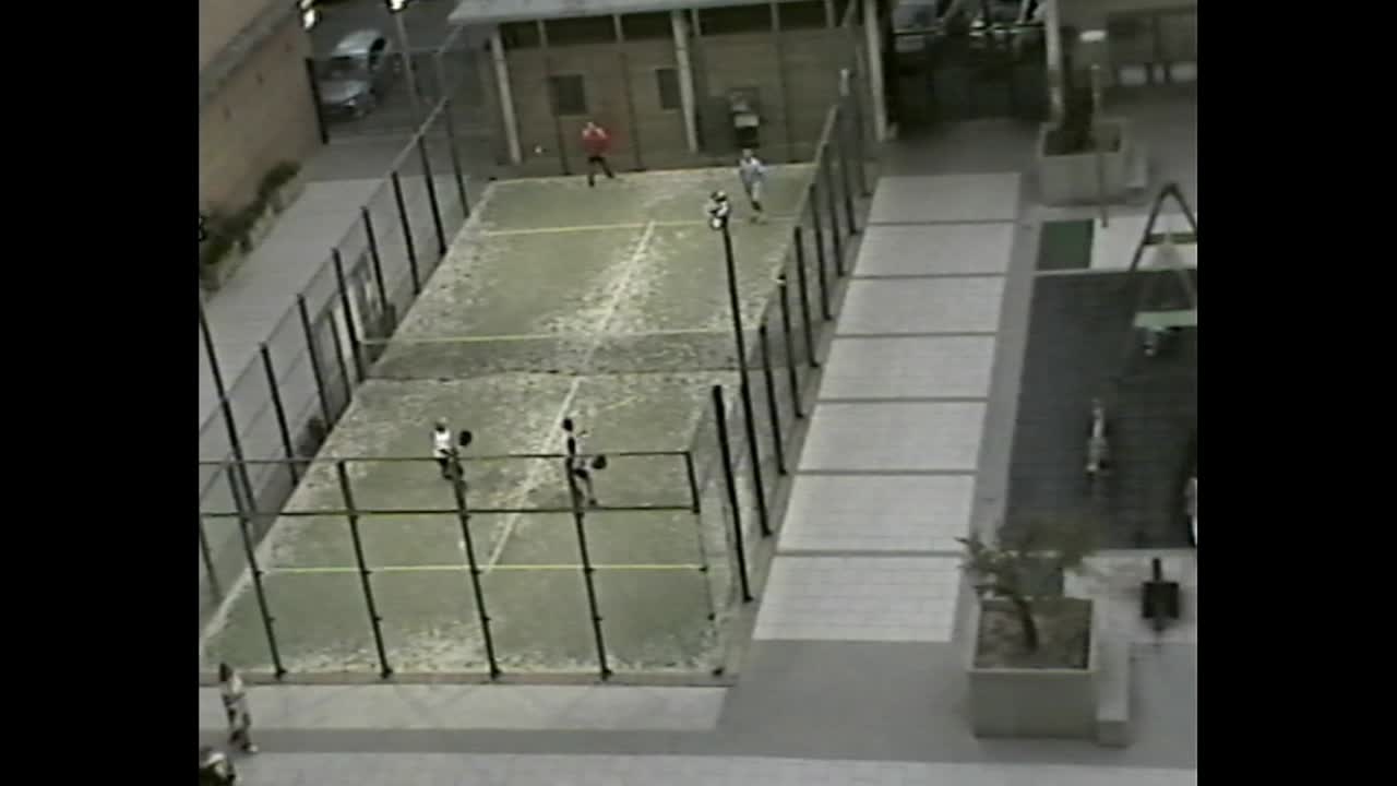 People playing paddle tennis in residential court