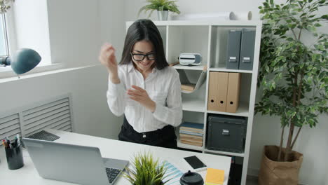 happy employees celebrating success in office