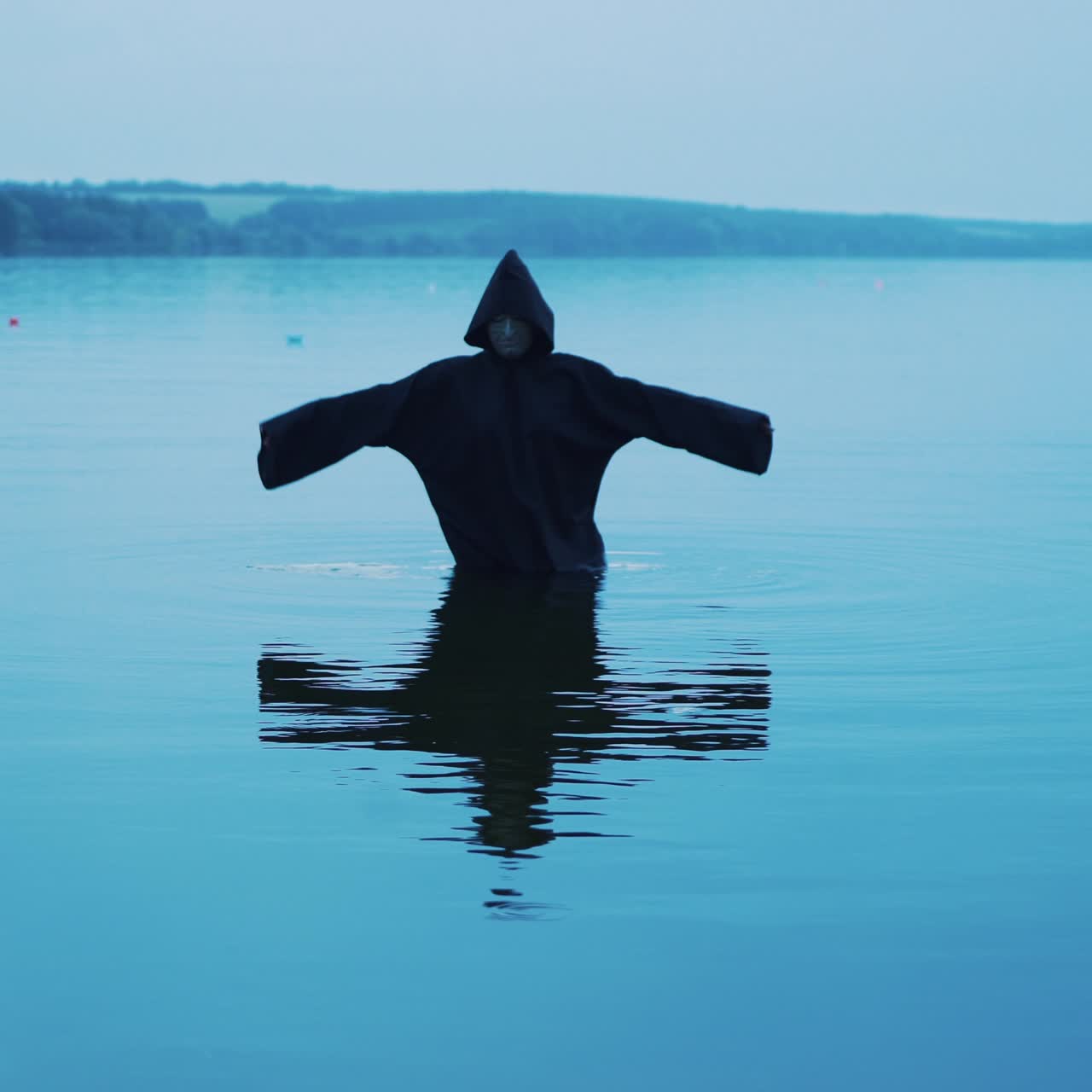 Evil Witch in a Black Hood in the River