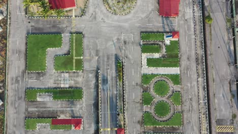 vertical top down aerial view, drone flyover driving training course at perak malaysia with palm trees