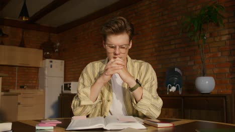 young man studying at home