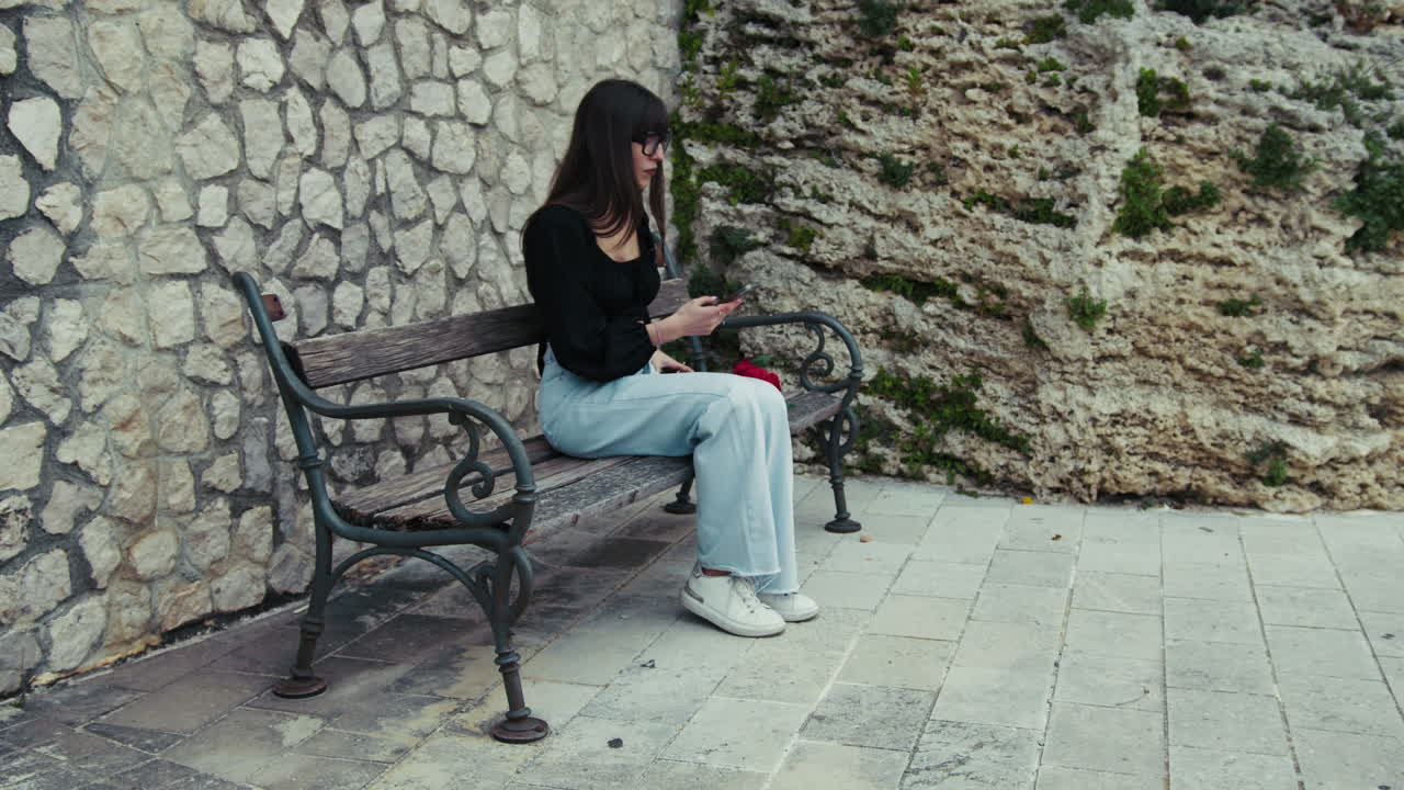 Woman On The Bench Picking Up The Smartphone To Make Some Photos