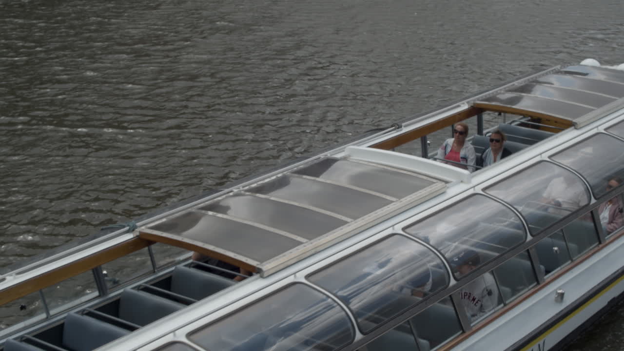 Tour boat with tourists on Amsterdam Canal