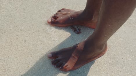 Die-Nackten-Knöchel-Und-Füße-Einer-Schwarzen-Person,-Die-In-Den-Weißen-Sand-Eines-Ozeanstrandes-Tritt