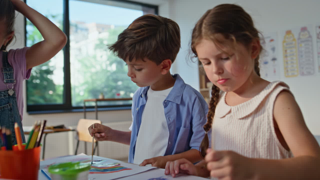 Creative children painting art lesson in elementary school closeup. Group pupils