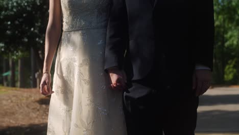 bride and groom holding hands slow motion