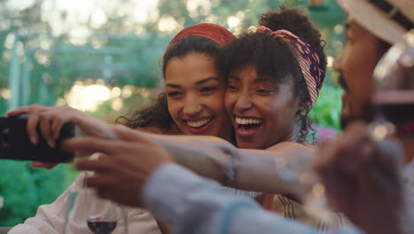 fun girl friends taking photo together using smartphone at dinner party enjoying summer sharing vacation memories on social media 4k