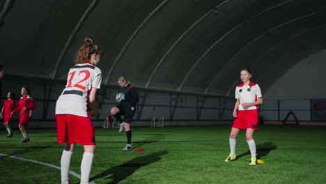 young female soccer players training indoors