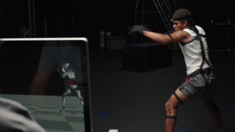 man wearing motion capture suit in studio performing martial arts actor boxing wearing mo-cap suit for 3d character computer game animation for virtual reality fighting gaming