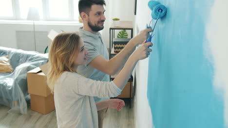 couple painting a wall in a new home