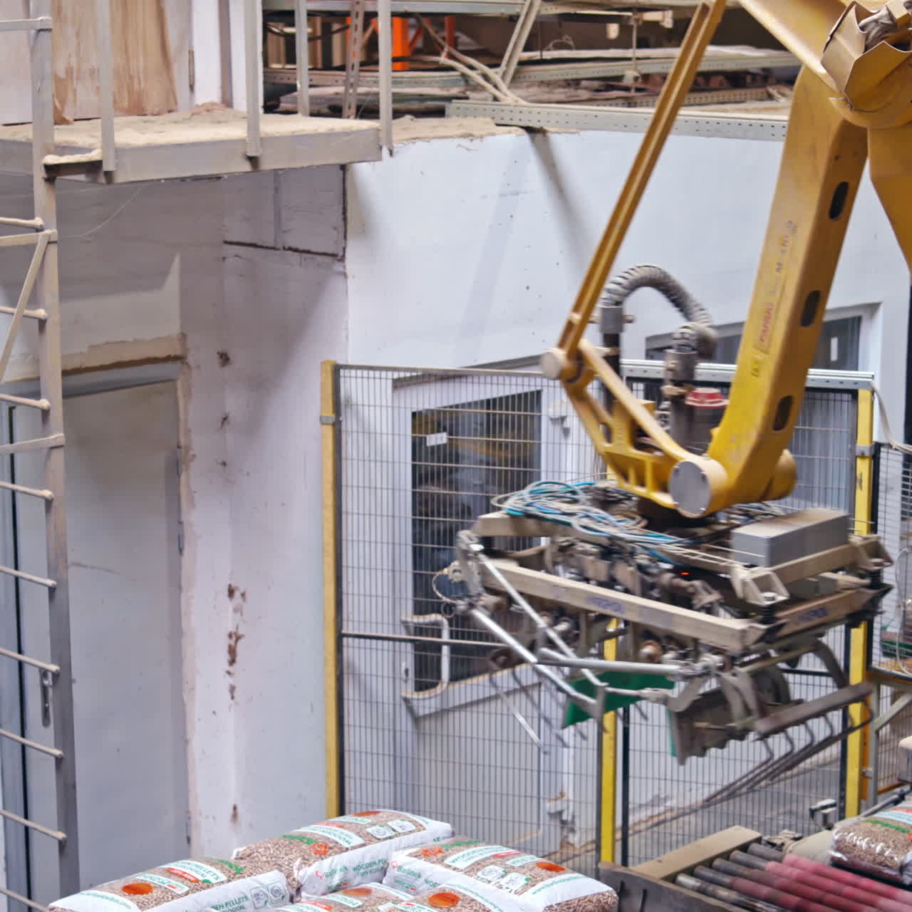Mechanical robot with artificial intelligence sorts bags on the conveyor. Putting bags from line to the pallet. Process closeup.
