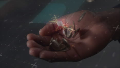 animación de chispas sobre monedas que caen en una mano