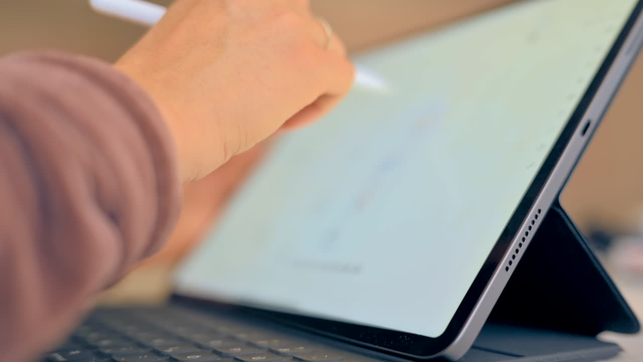 Woman sketching on a graphic tablet with a stylus pen