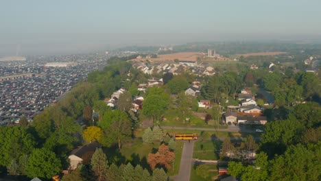 Yellow-School-Bus-in-USA-drives-on-street,-picking-up-students-on-foggy-morning