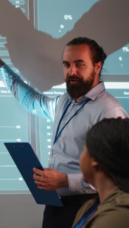vertical video diverse corporate consultants reviewing feedback and targets