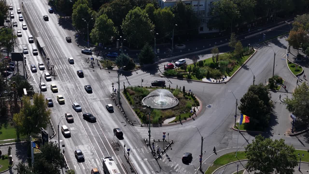 Rotating Aerial View Over Constantin Brancoveanu Square with Traffic Below and a Fountain in the Middle, Bucharest, Romania