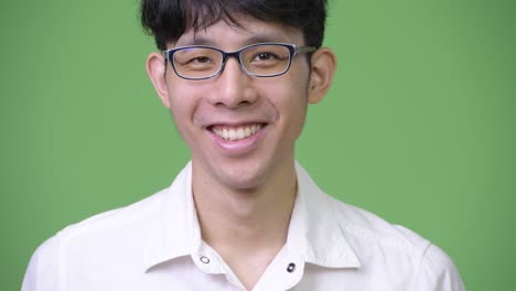 head shot of young asian businessman smiling