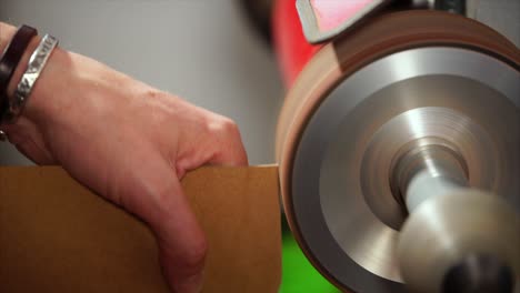 person sanding wood with a machine