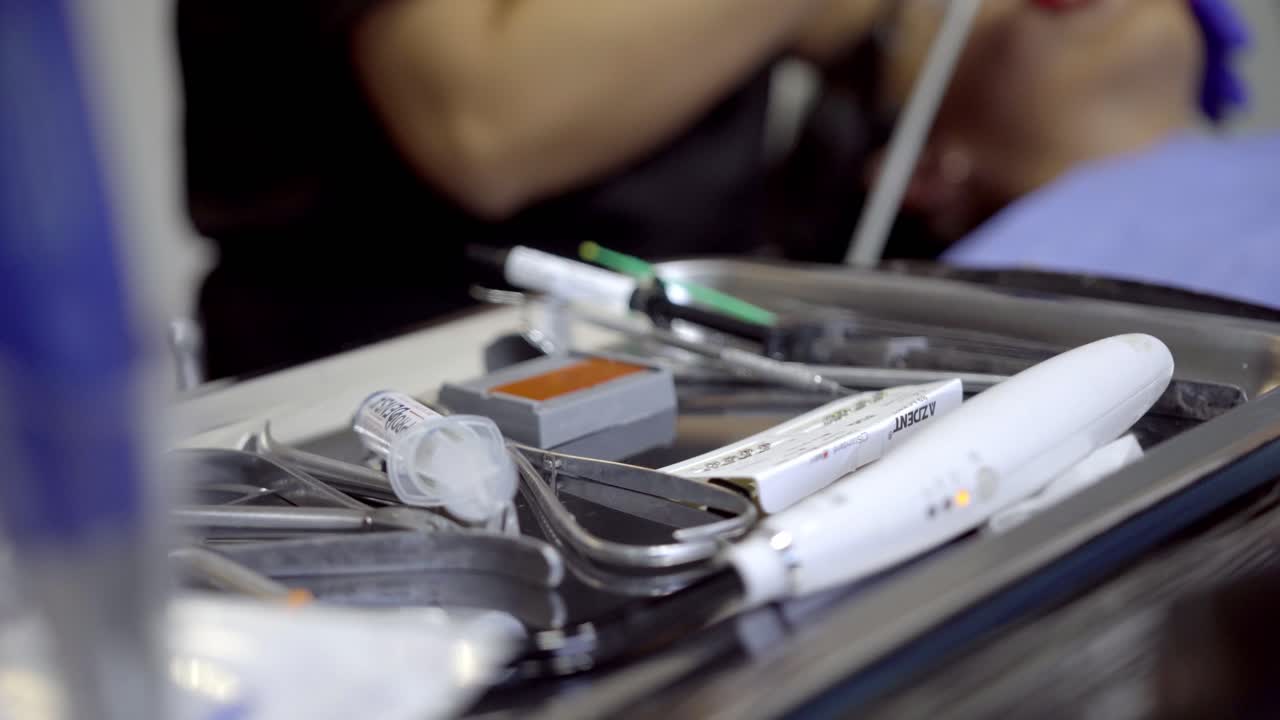 Close up of a dentist using precision tools while preparing instruments during a dental procedure
