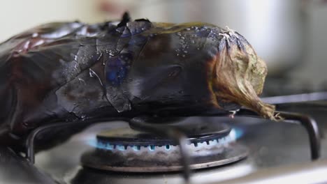 a piece of american eggplant roasting over stove