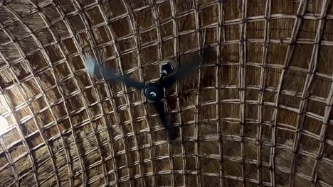 ceiling fan in a tropical thatched hut