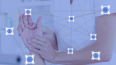 medical icons and network connections animation over person examining hand