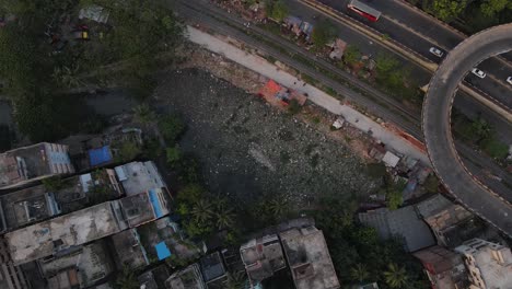 Polluted-lake-filled-with-garbage-in-a-city-beside-highway-and-railroad