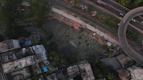 polluted lake filled with garbage in a city beside highway and railroad