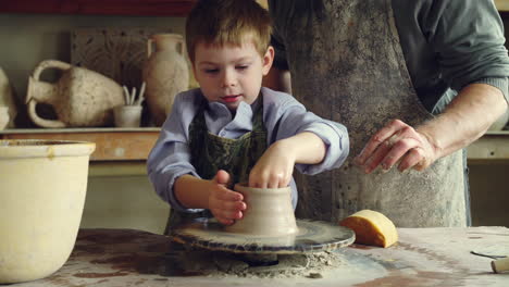 child learning pottery from a master craftsman