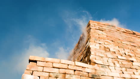 stacked clay bricks being fired in clamp kiln, smoke and heat escaping