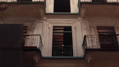 A-tilt-through-the-front-of-an-abandoned-building-showcasing-the-Hispanic-architectures-of-the-old-city-at-Casco-Viejo,-now-part-of-a-restoration-project-to-preserve-the-citys-heritage,-Panama-City