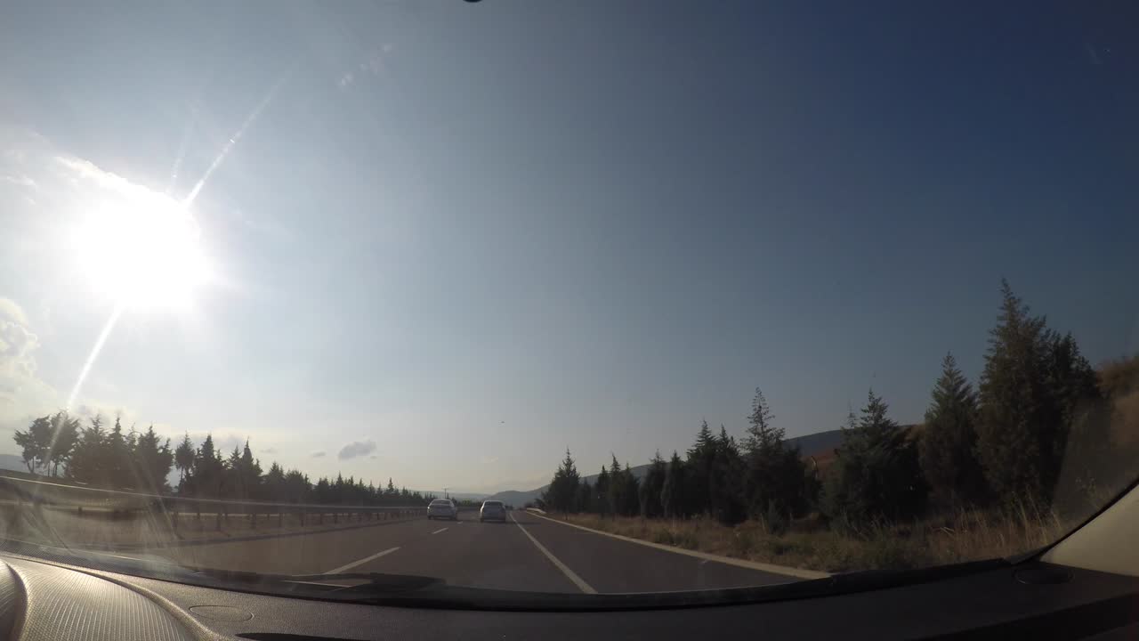 City, nature and traffic view from the camera inside the vehicle.