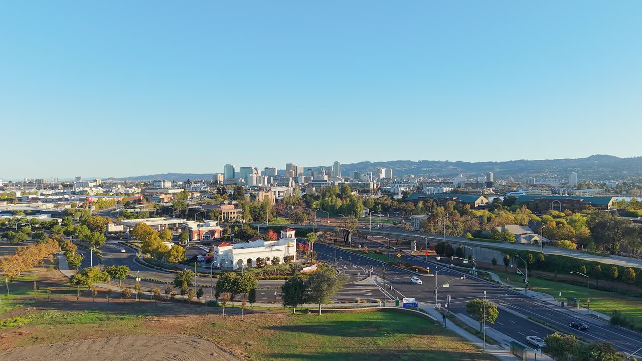 The drone glides over Webster Street in West Alameda, showcasing the neighborhood’s vibrant storefronts and the gentle flow of traffic below