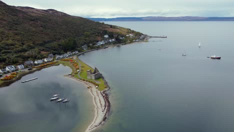 aerial view of lochranza castle on the isle of arran on an overcast day, scotland