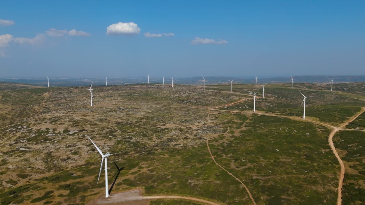 Aerial descending shot revealing a large windfarm not generating energy