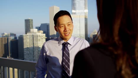 hispanic female talking strategy with asian male colleague