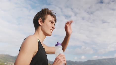 young man exercising outdoors taking a break