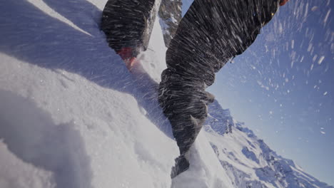 a professional skier hikes up a steep ridge in verbier, then drops into an epic freeride descent. pure adventure skiing in deep snow, dramatic terrain, and breathtaking alpine scenery.
