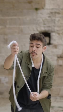 man performing a rope magic trick